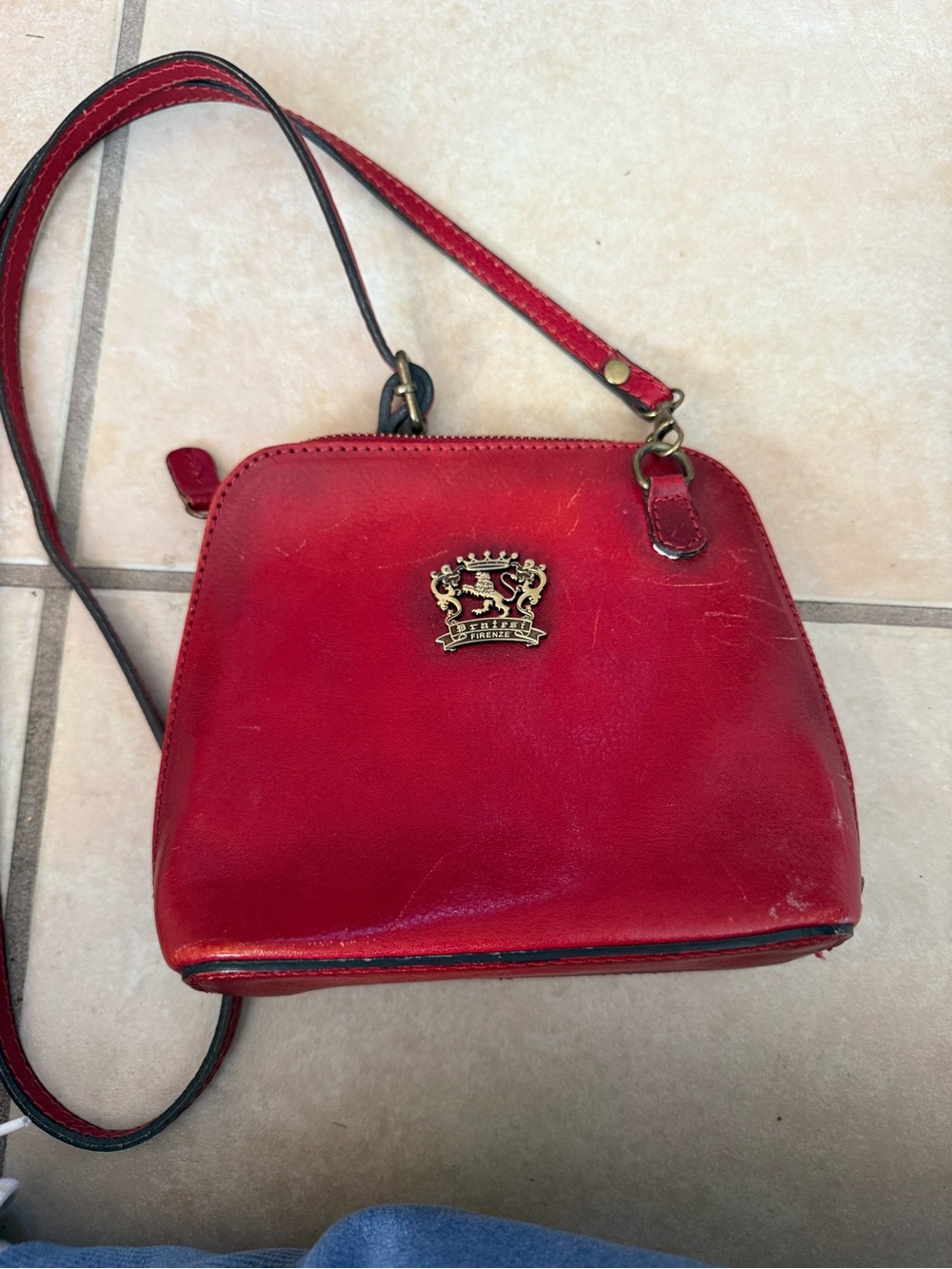Red Leather Crossbody with Decorative Crest Accent